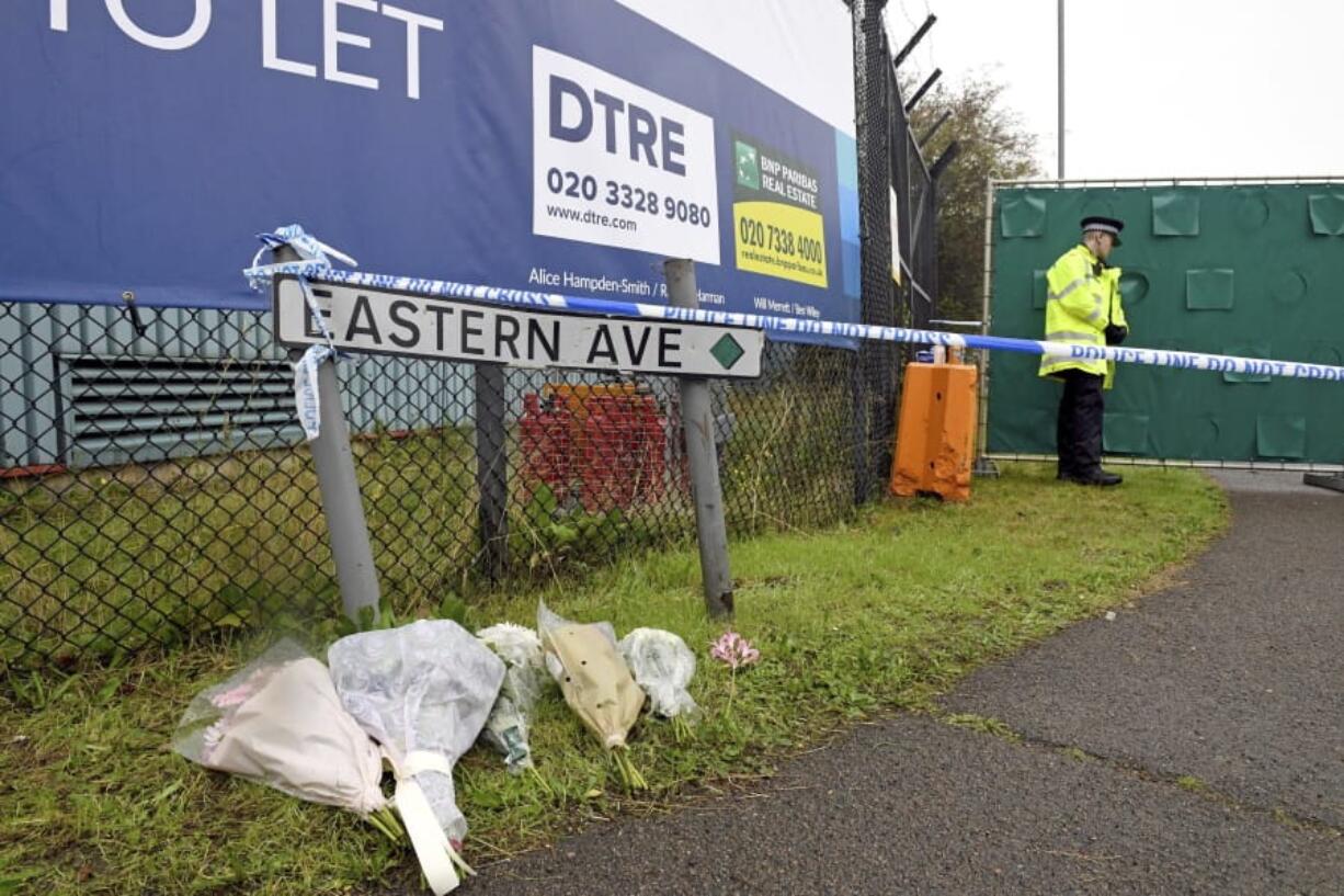 Floral tributes at the Waterglade Industrial Park in Thurrock, Essex, England Thursday Oct. 24, 2019 the day after 39 bodies were found inside a truck on the industrial estate. British media are reporting that the 39 people found dead in the back of a truck in southeastern England were Chinese citizens.