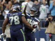 Seattle Seahawks wide receiver DK Metcalf, right, celebrates with D.J. Fluker (78) after scoring a touchdown against the Tampa Bay Buccaneers during the second half of an NFL football game, Sunday, Nov. 3, 2019, in Seattle.