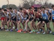 The Camas boys cross country team including, in red from left, Sam Geiger, Evan Jenkins and Luc Utheza, line up at the start of the WIAA Class 4A State Cross Country Championships on Saturday in Pasco.