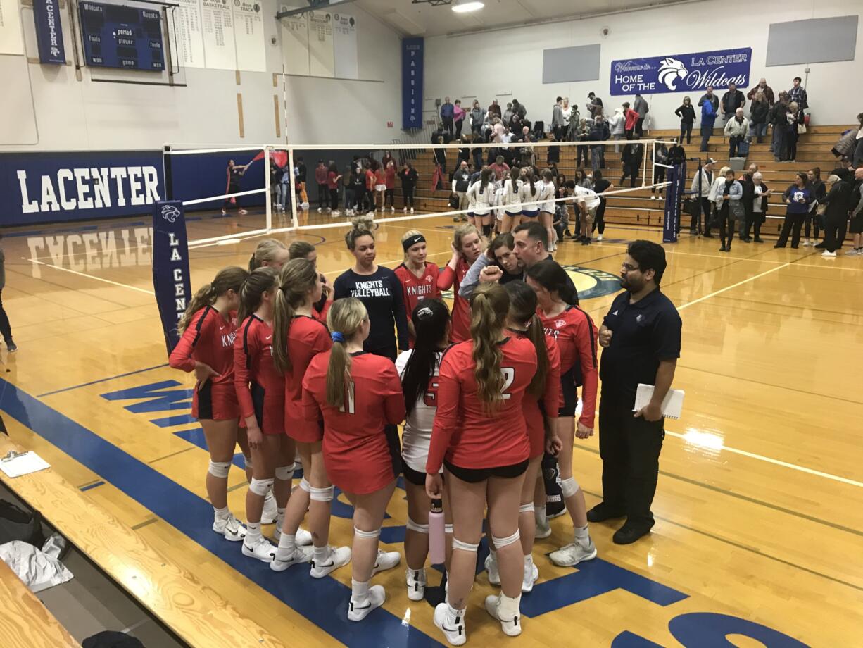 King’s Way Christian players celebrate their five-set district semifinal win Wednesday over La Center.