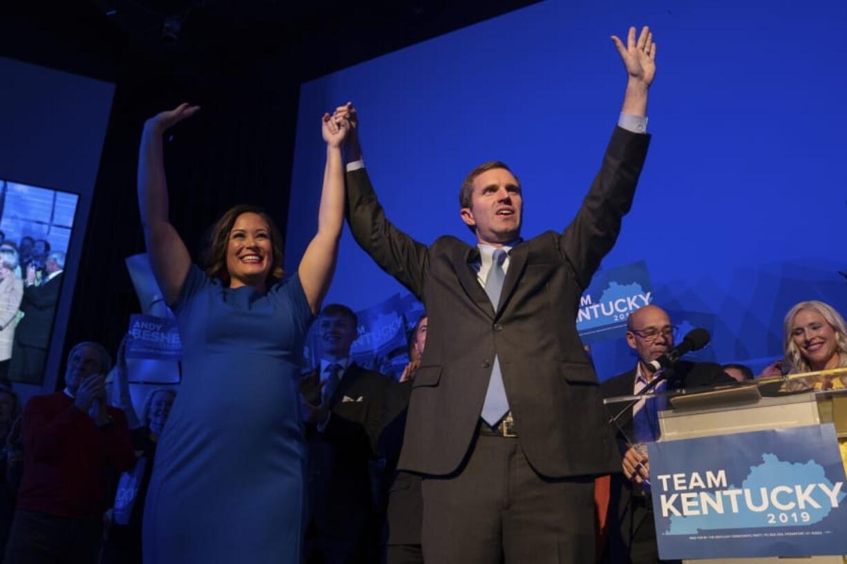 Democratic gubernatorial candidate and Kentucky Attorney General Andy Beshear, along with lieutenant governor candidate Jacqueline Coleman, acknowledge supporters at the Kentucky Democratic Party election night watch event, Tuesday, Nov. 5, 2019, in Louisville, Ky.