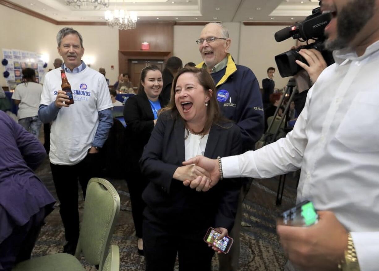 Candidate for the 94th District, Shelly Simonds, celebrates with supporters as election results begin to come in Tuesday, Nov. 5, 2019, at the Marriott in Newport News, Va.