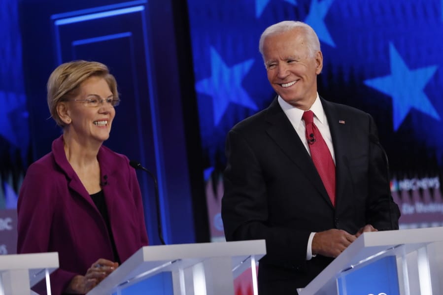 Democratic presidential candidate former Vice President Joe Biden speaks as Democratic presidential candidate Sen. Elizabeth Warren, D-Mass., listens during a Democratic presidential primary debate, Wednesday, Nov. 20, 2019, in Atlanta.