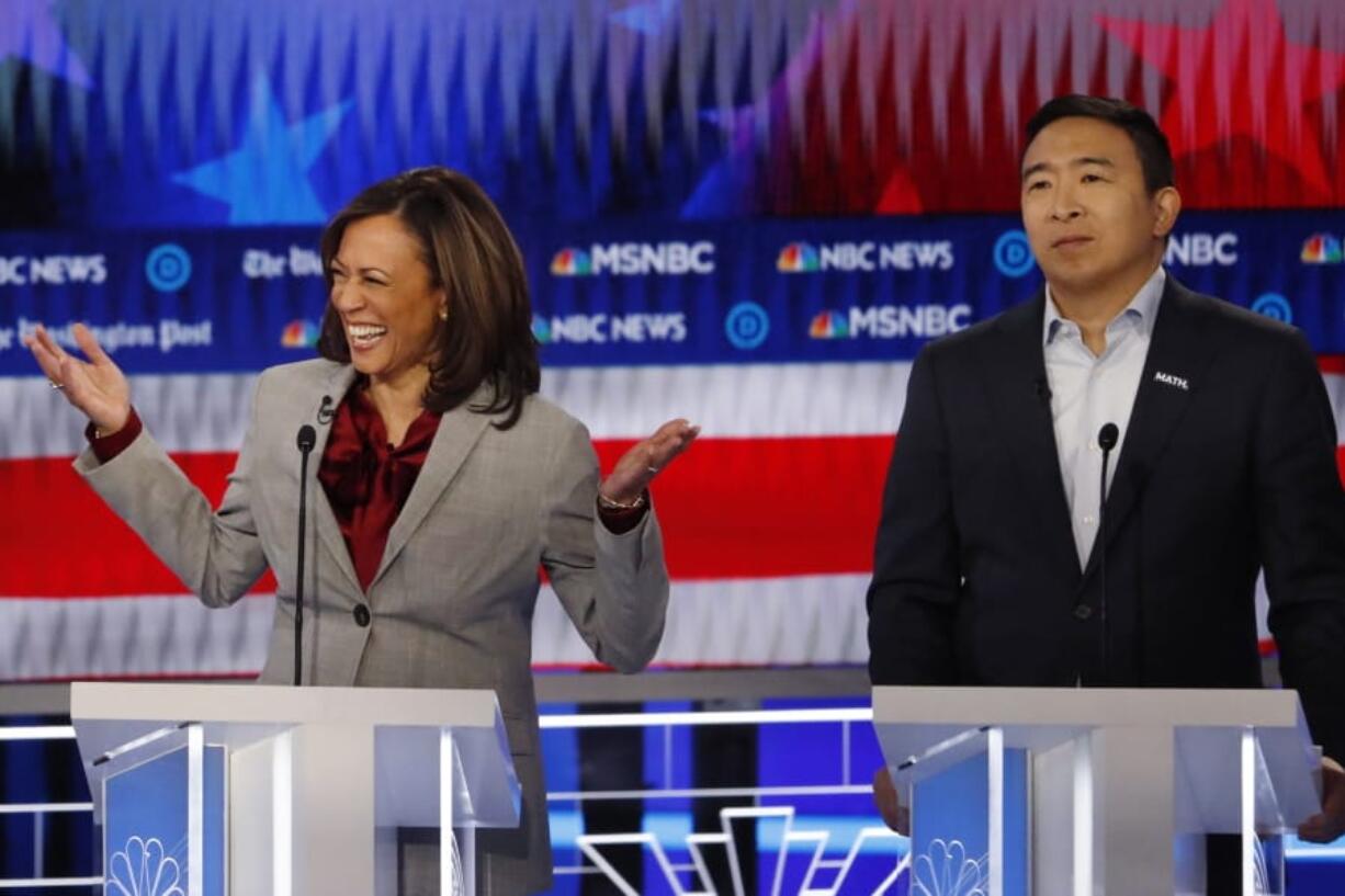 Democratic presidential candidate Sen. Kamala Harris, D-Calif., reacts while speaking as Democratic presidential candidate former technology executive Andrew Yang looks on during a Democratic presidential primary debate, Wednesday, Nov. 20, 2019, in Atlanta.