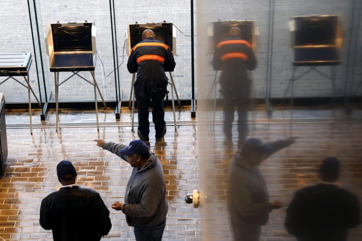 FILE - In this Nov. 5, 2019, file photo, voters cast their ballots at Hampton City Hall, in Hampton, Va. As election results came in last week from Kentucky and Virginia, social media posts offered an unsubstantiated explanation for Republican losses: voter fraud. The responses offer a glimpse into the type of misinformation that could cloud next year&#039;s presidential race.