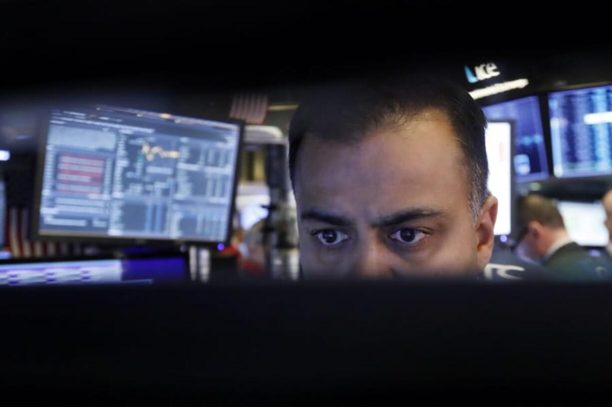 FILE - In this Nov. 20, 2019, file photo specialist Dilip Patel watches the screens at his post on the floor of the New York Stock Exchange. The U.S. stock market opens at 9:30 a.m. EST on Wednesday, Nov 27.