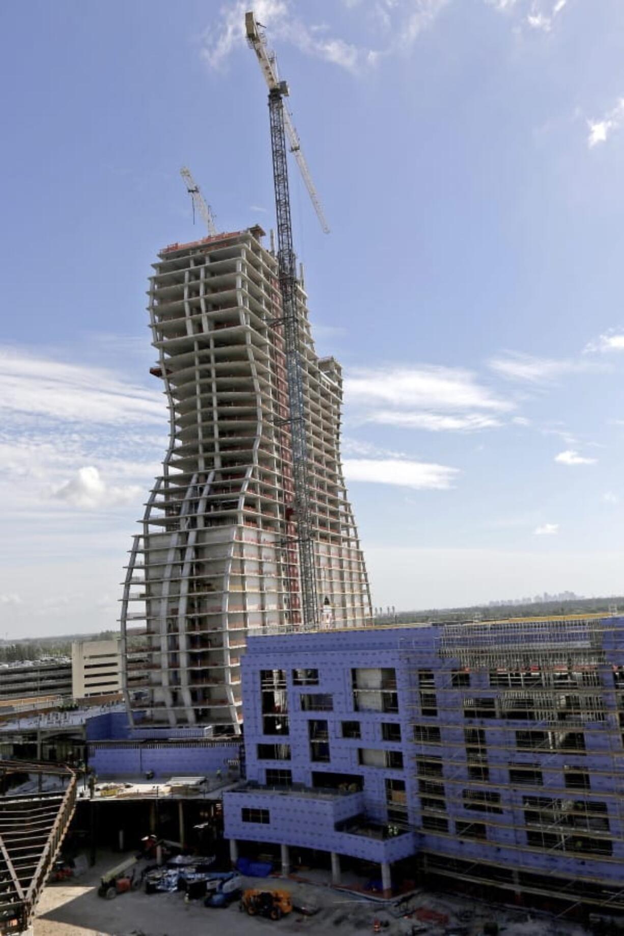 FILE - In this July 9, 2018 file photo, the new guitar tower is constructed as part of the guitar-shaped Seminole Hard Rock Hotel and Casino slated to open next year in Hollywood, Fla.  It looks like the guitar Led Zeppelin&#039;s Jimmy Page played. But this one is 450 feet (137 meters) tall and is a light-beam hotel that the Seminole Tribe wants to become South Florida&#039;s latest tourist destination. The Guitar Hotel&#039;s grand opening is Thursday, Oct. 24, 2019, on the tribe&#039;s land in Hollywood. It&#039;s the latest step in the Seminole Hard Rock empire, which includes naming rights on the Miami-area stadium where the 2020 Super Bowl will be played.