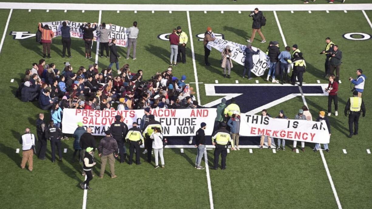 A climate change protest delayed the start of the second half of an NCAA college football game between Harvard and Yale on Saturday in in New Haven, Conn.