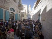 Christian clergymen, carry a wooden relic believed to be from Jesus&#039; manger outside the Church of the Nativity, traditionally believed by Christians to be the birthplace of Jesus Christ in the West Bank city of Bethlehem, Saturday, Nov. 30, 2019. A tiny wooden relic believed to have been part of Jesus&#039; manger has returned to its permanent home in the biblical city of Bethlehem 1,400 years after it was sent to Rome as a gift to the pope.