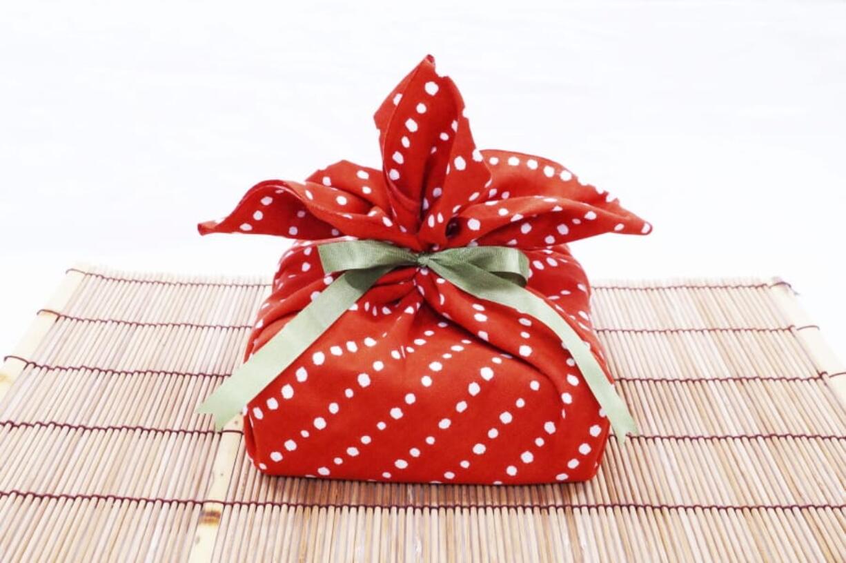 A traditional Tenugui cloth, similar to furoshiki, is used as an alternative to traditional gift wrapping.