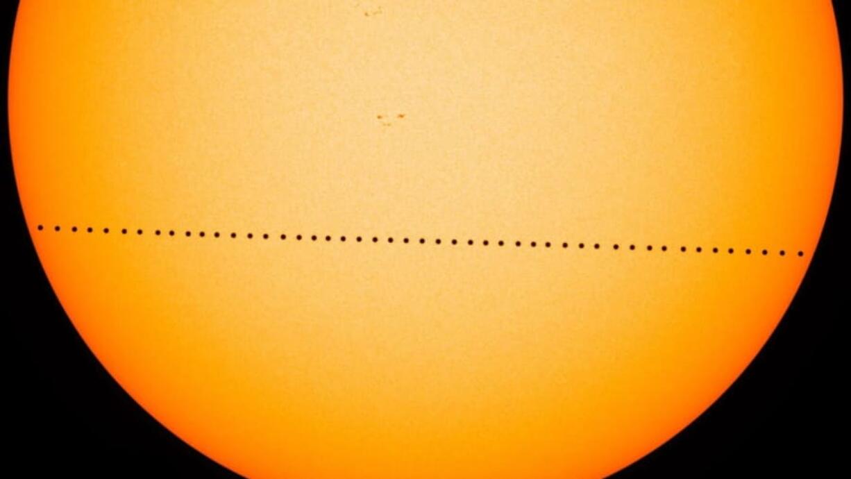 In this composite image, the planet Mercury is visible as it passes directly between the sun and Earth on May 9, 2016, in a transit which lasted 7 1/2  hours. On Monday morning, Mercury will make another transit.