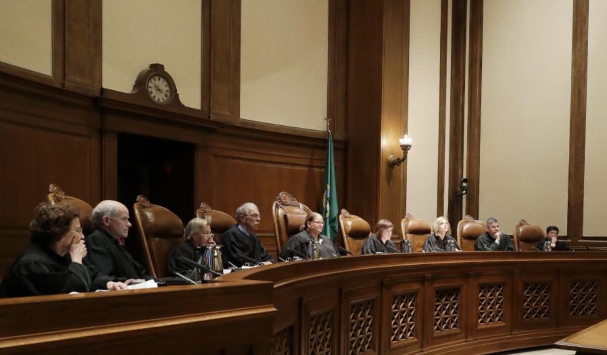 FILE - In this Jan. 22, 2019 file photo, justices on the Washington Supreme Court listen to testimony in Olympia, Wash. On Wednesday, Nov. 6, 2019, Justice Debra Stephens, third from right, was elected by her fellow members of the court to be the new chief justice to replace of the state Supreme Court to be the new chief justice to replace current Chief Justice Mary Fairhurst, center, who announced last month she will retire from the high court in January to focus on her health. (AP Photo/Ted S.