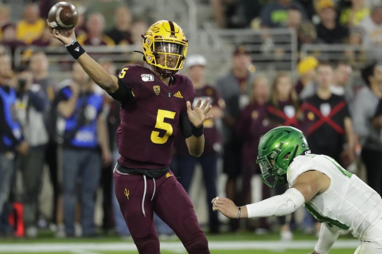 Arizona State quarterback Jayden Daniels (5) throws under pressure from Oregon linebacker Isaac Slade-Matautia during the second half of an NCAA college football game Saturday, Nov. 23, 2019, in Tempe, Ariz. Arizona State won 31-28.