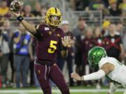 Arizona State quarterback Jayden Daniels (5) throws under pressure from Oregon linebacker Isaac Slade-Matautia during the second half of an NCAA college football game Saturday, Nov. 23, 2019, in Tempe, Ariz. Arizona State won 31-28.