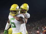 Oregon wide receiver Juwan Johnson, left, celebrates his touchdown with running back Travis Dye during the second half of an NCAA college football game against Southern California, Saturday, Nov. 2, 2019, in Los Angeles.