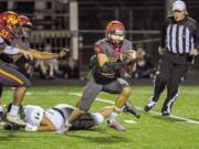 Dustin Shelby recovers a fumble and runs it in for a 16-yard touchdown in Prairie’s 42-14 win over Evergreen on Friday at District Stadium in Battle Ground.