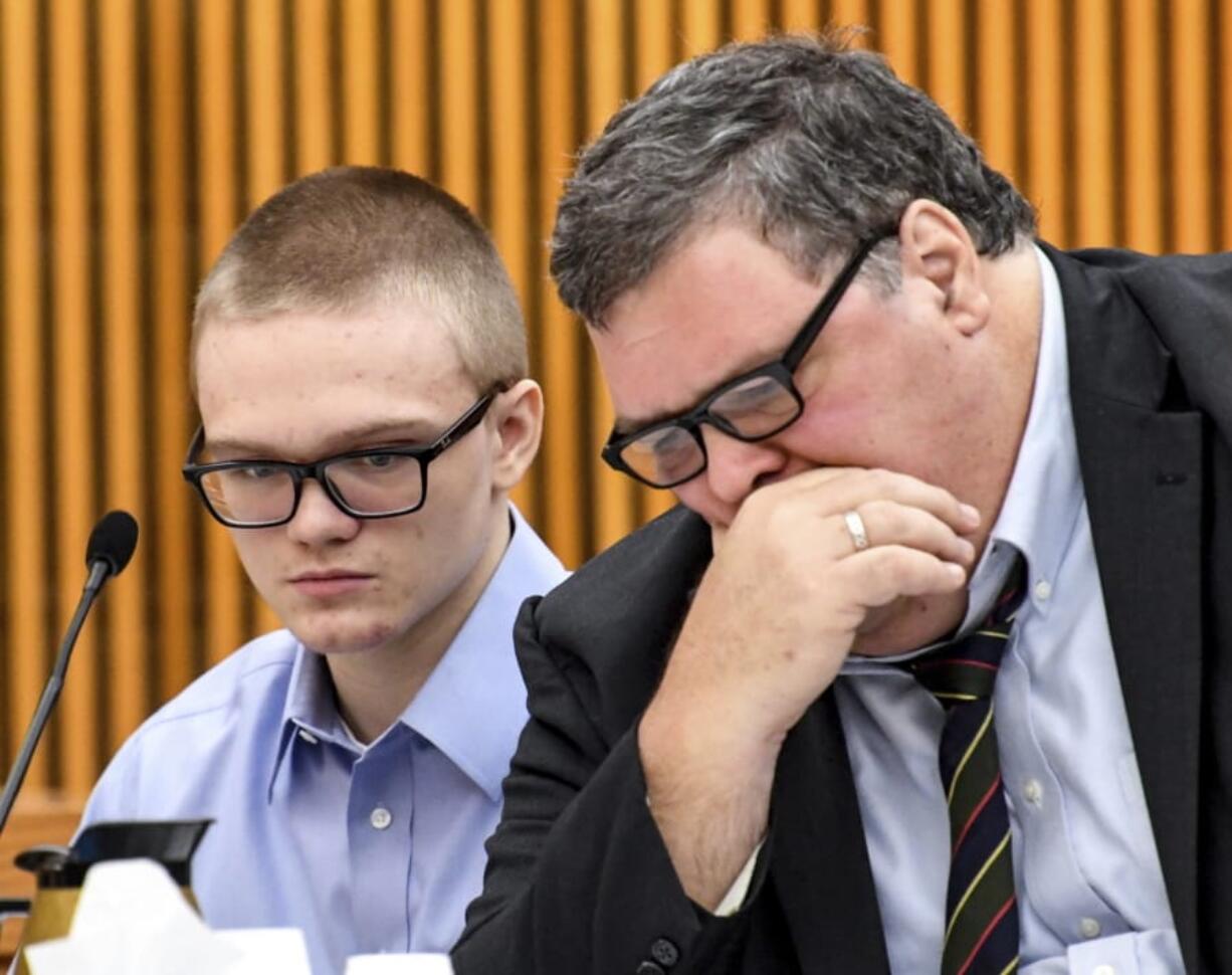 Jesse Osborne talks with attorney Frank Eppes during a sentence-related hearing at the Anderson County Courthouse, Wednesday, Nov. 13, 2019, in Anderson, S.C.  Osborne, a teen who killed his father at home before fatally shooting a first-grader on a South Carolina elementary school playground, is either a traumatized son who can be rehabilitated or a dangerous and pathological liar with no remorse, according to the conflicting testimony of two mental health professionals Wednesday.