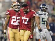 San Francisco 49ers wide receiver Emmanuel Sanders (17) yells next to running back Matt Breida (22) and Seattle Seahawks middle linebacker Bobby Wagner (54) during the first half of an NFL football game in Santa Clara, Calif., Monday, Nov. 11, 2019.