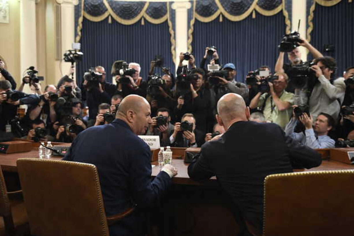 U.S. Ambassador to the European Union Gordon Sondland, left, arrives to testify before the House Intelligence Committee on Capitol Hill in Washington, Wednesday, Nov. 20, 2019, during a public impeachment hearing of President Donald Trump's efforts to tie U.S. aid for Ukraine to investigations of his political opponents. At right is his attorney Robert Luskin.