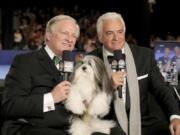 David Frei, left, and host John O&#039;Hurley pose with a Havanese dog at The National Dog Show in Philadelphia.