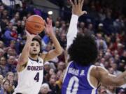 Gonzaga guard Ryan Woolridge (4) shoots over Texas-Arlington guard Brian Warren (0) during the second half of an NCAA college basketball game in Spokane, Wash., Tuesday, Nov. 19, 2019. Gonzaga won 72-66.