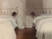 This October 1968 family photo shows Katie Bowman as a child, right, in her room in Waterloo, Iowa. Bowman&#039;s parents welcomed into their religious home three priests who molested her, she said, starting when she was around 4, a few months after this photo was made.