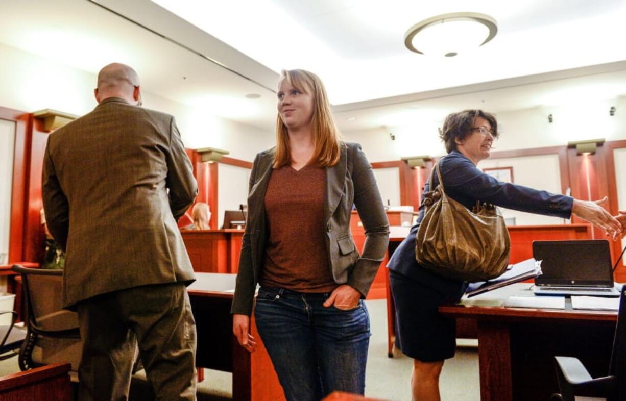 Tilli Buchanan smiles as she leaves Judge Kara Pettit&#039;s Third District Courtroom, Tuesday, Nov. 19, 2019, in Salt Lake City. Her attorneys Leah Farrell, with the American Civil Liberties Union of Utah, and Randy Richards argued on her behalf that Utah&#039;s lewdness statute is unconstitutional because it discriminates against women. Buchanan is facing charges of lewdness involving a child after police say she took off her top while cleaning out the garage and her stepchildren saw her topless. Pettit is expected to rule in two months.