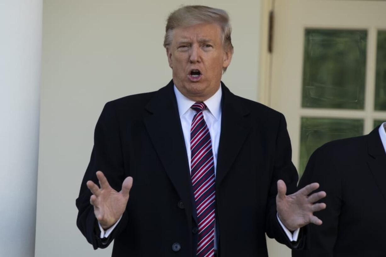 President Donald Trump talks with reporters during a visit by Conan, the U.S. Army dog that participated in the raid that killed ISIS leader Abu Bakr al-Baghdadi, in the Rose Garden of the White House, Monday, Nov. 25, 2019, in Washington.