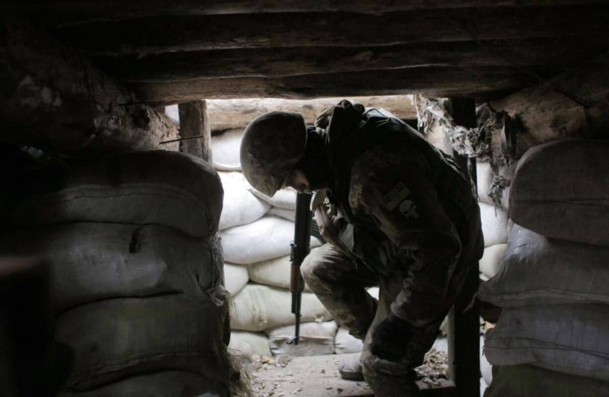 In this photo taken on Monday, Nov. 18, 2019, a Ukrainian soldier is seen in a trench in the front line near the town of Avdiivka in the Donetsk region, Ukraine.