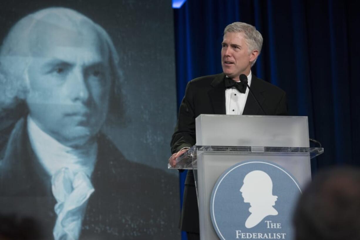 FILE - In this Nov. 16, 2017, file photo, Supreme Court Associate Justice Neil Gorsuch speaks at the Federalist Society&#039;s 2017 National Lawyers Convention in Washington. A liberal activist group is launching a digital ad campaign targeting the Federalist Society, a conservative legal organization that has championed judges appointed by President Donald Trump, including Supreme Court Justices Brett Kavanaugh and Gorsuch. The ads, to appear on LinkedIn and Facebook, target major law firms that were sponsored the Federalist Society&#039;s annual dinner.