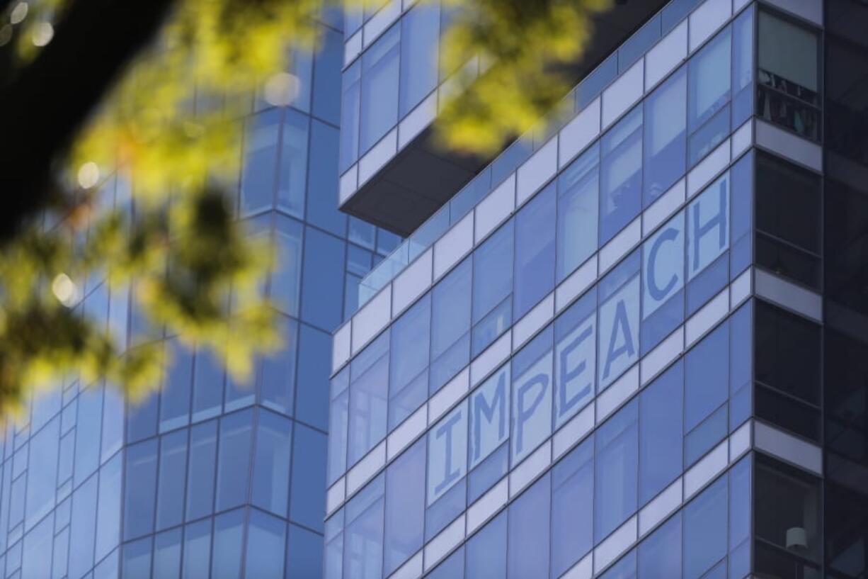 A sign in favor of impeachment is displayed in the windows of an office building near Madison Square Park before President Donald Trump&#039;s speech to kick off New York City&#039;s 100th annual Veterans Day parade, Monday, Nov. 11, 2019.