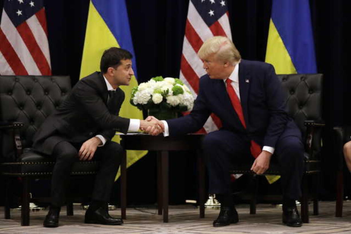 In this Wednesday, Sept. 25, 2019 file photo, President Donald Trump meets with Ukrainian President Volodymyr Zelenskiy at the InterContinental Barclay New York hotel during the United Nations General Assembly in New York. The House impeachment inquiry is zeroing in on two White House lawyers privy to a discussion about moving a memo recounting President Donald Trump’s phone call with the leader of Ukraine into a highly restricted computer system normally reserved for documents about covert action.