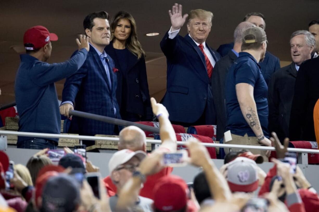 President Donald Trump and first lady Melania Trump, third from left, arrive for Game 5 of the World Series baseball game between the Houston Astros and the Washington Nationals at Nationals Park in Washington, Sunday, Oct. 27, 2019. Also pictured are Rep. Matt Gaetz, R-Fla., second from left, and Rep. Mark Meadows, R-N.C, right.