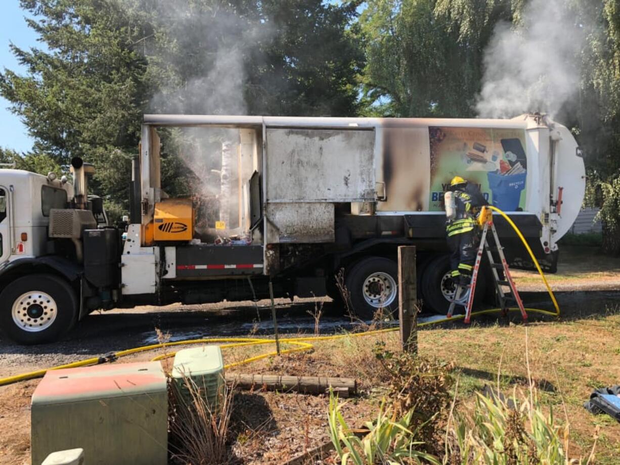 A hole was cut in the side of this Waste Connections recycling truck so Vancouver firefighters could douse a fire in September 2018.