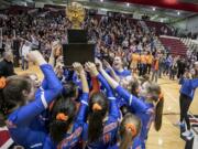 The Ridgefield High School volleyball team celebrates their WIAA 2A girls championship win with their fans after the Spudders defeats the Ellensburg Bulldogs 3-1 on Saturday, Nov. 16, 2019, at the Nicholson Pavilion in Ellensburg, Wash.