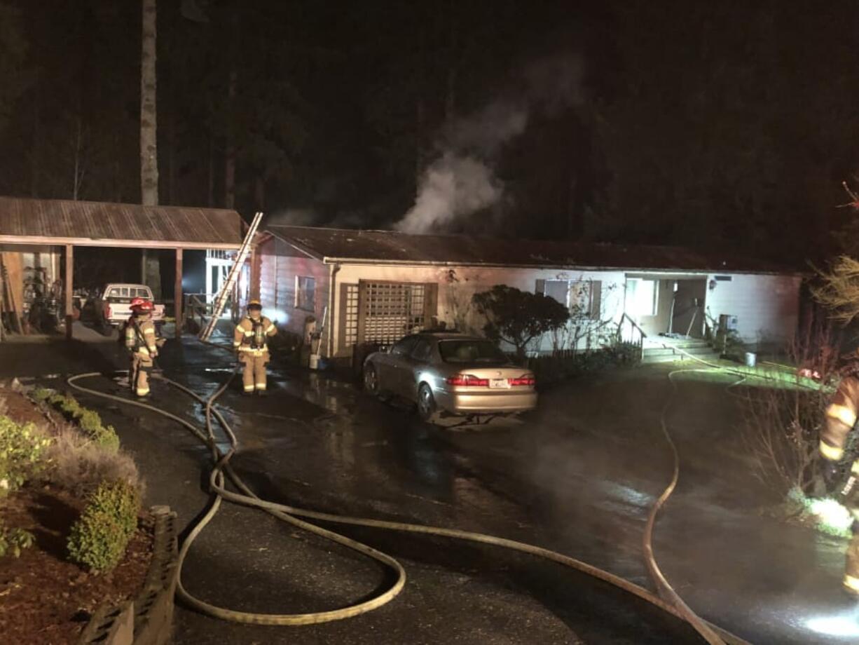 A fire that displaced two people Wednesday night in north Clark County is believed to have been caused by an overheated wood stove.