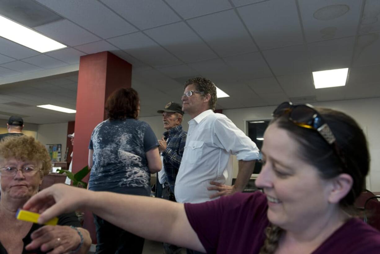 Recovery Cafe Clark County offers karaoke jam sessions monthly. Program coordinator William O&#039;Connor, at center, waits for his turn to sing while Becky Gonzales, at right, plays Jumbling Tower with her mother Dorothy Lies, both of Vancouver.