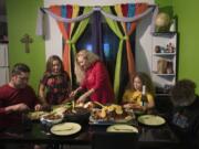 Ramon Flores, 46, from left, formerly of Hazel Dell, sits down to Thanksgiving dinner at his apartment in Tijuana, Mexico, with his daughter, Rayma, 10, wife, Enedis, 54, daughter, Kennedy, 16, and son, Raymond, 15. His family, who now lives in Chula Vista, Calif., crossed the U.S.-Mexico border shortly before midnight Wednesday so they could be together for the American holiday.