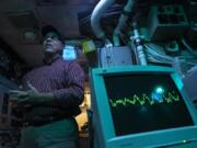 Mark Manzer, who served in the sonar room on the USS Sam Houston, talks about his service while leading a tour of the USS Blueback at the Oregon Museum of Science and Industry.