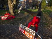 Sign spinner Jeremiah Zueger, left, and Chance Jordan, general manager of AArrow Sign Spinners practice in Esther Short Park in Vancouver on a recent November afternoon.