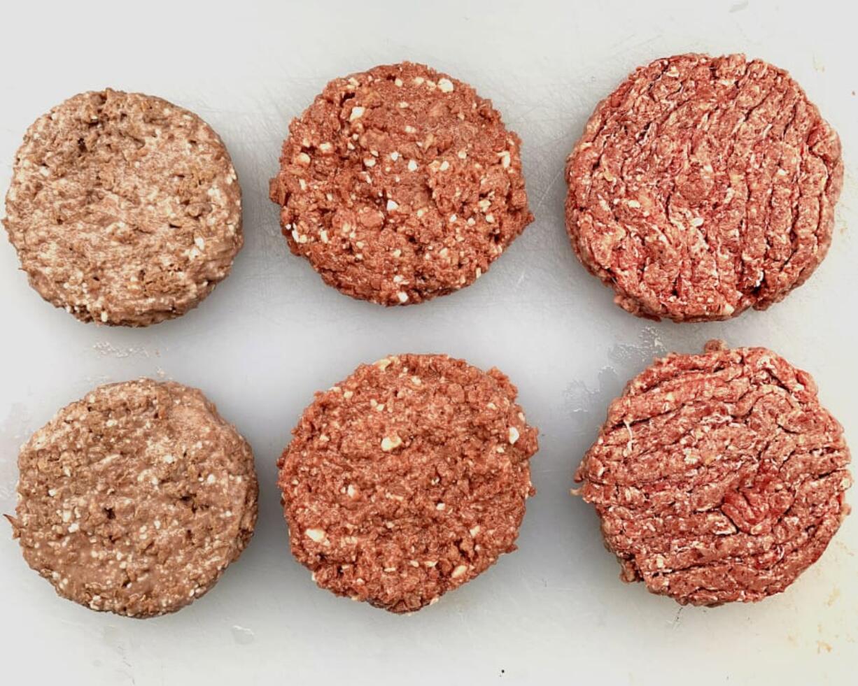 Uncooked Beyond Beef, from left, Impossible Burger and beef burger.