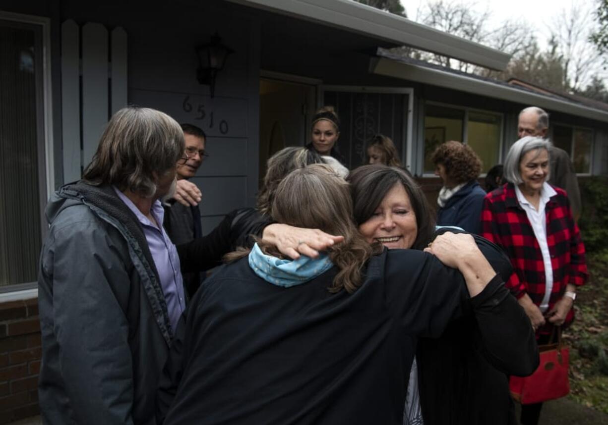 Val Valenzuela, volunteer with A Warrior's Way, embraces Dawn Schultz, outreach manager, secretary and treasurer with A Warrior' Way, during a ribbon cutting for new transitional housing for veterans on Tuesday.