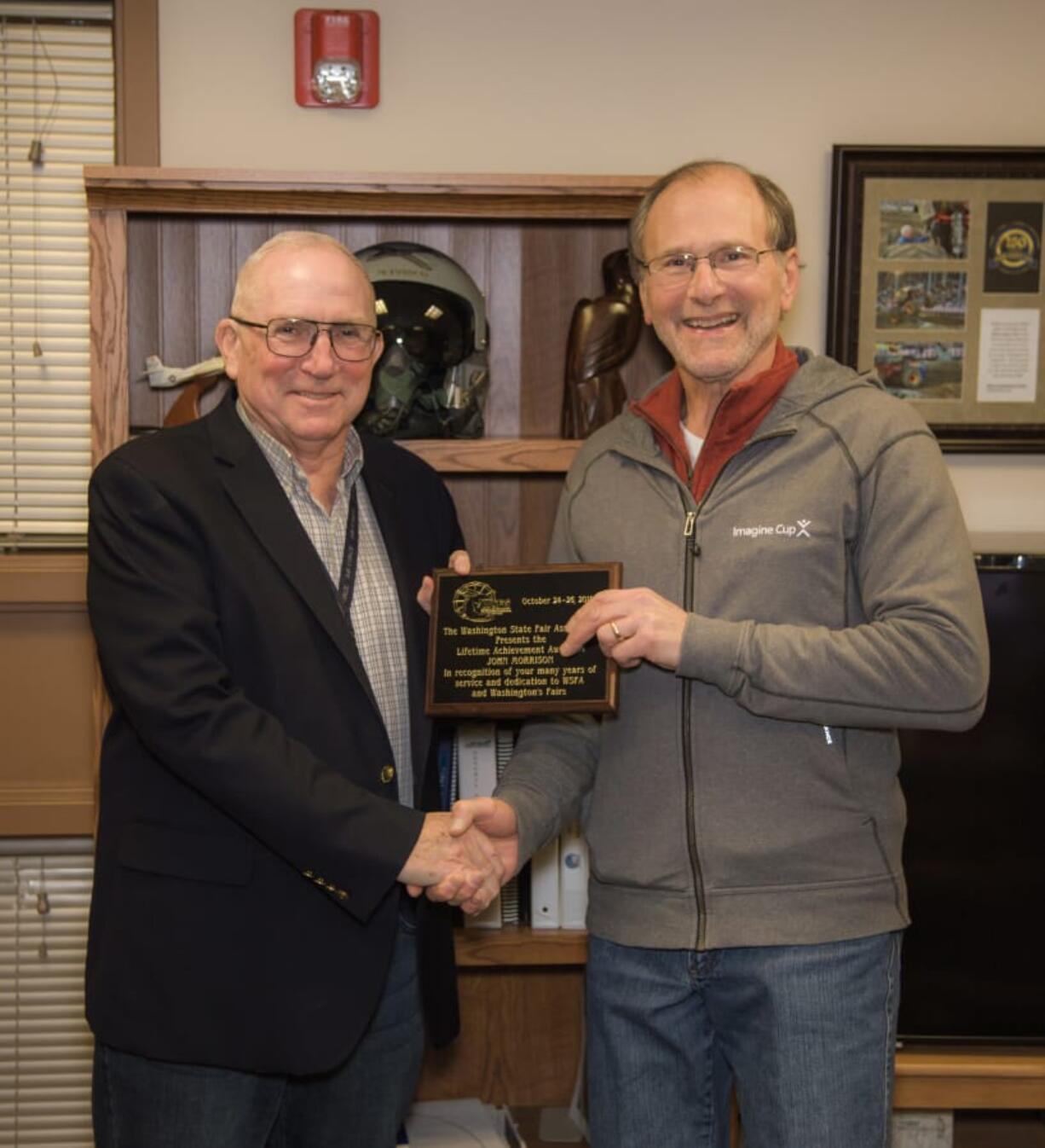 Fairgrounds: Retired Clark County Fair Manager and CEO John Morrison, left, is presented with a Lifetime Achievement Award from the Washington State Fairs Association by Scott Horenstein with the Clark County Fair Association.