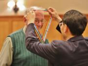 VANCOUVER MALL: Richard Woods of Kelso was presented an Ambassador for Peace Medal by Consul General Lee Hyung-jong, Republic of Korea. Eleven veterans with an Ambassador for Peace Medal at a Nov.