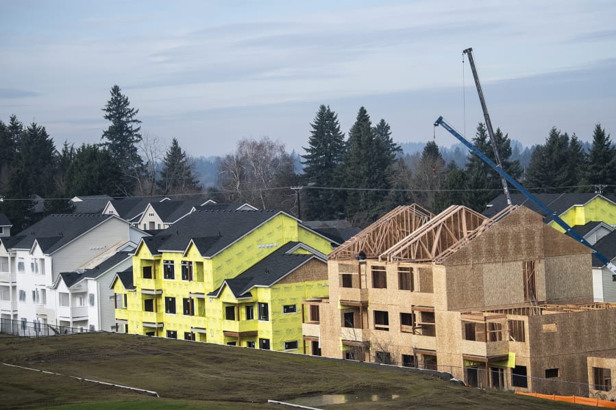 Construction crews work on apartment buildings at the Latitude 45 development, a Ginn Group project near the Four Seasons subdivision in east Vancouver. Ginn Group typically builds single-family detached housing and townhomes; the apartment project represents a new push into multi-family units and rental properties.