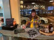 Slow Food Southwest Washington board member Chelsea Unger sells merchandise at the organization&#039;s recent annual meeting.