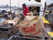 Bags of shelf-stables foods fill numerous shopping carts at the Walk &amp; Knock food drive at Chuck&#039;s Produce on Saturday. Chuck&#039;s was one of 10 drop-off sites for the food drive.