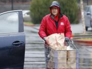 Charlie Atkinson, Walk &amp; Knock food drive site coordinator, helps unload donated food at Chuck&#039;s Produce. Atkinson said there was a good response from area residents, who willingly donated a stream of shelf-stable foods.