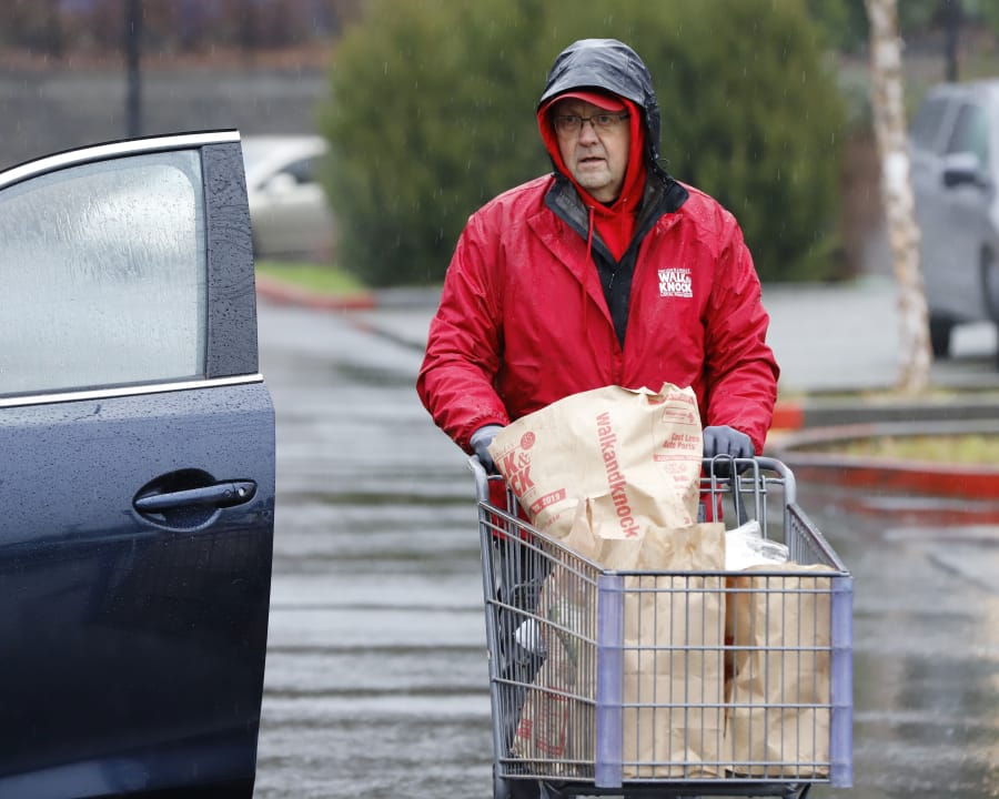 Charlie Atkinson, Walk &amp; Knock food drive site coordinator, helps unload donated food at Chuck&#039;s Produce. Atkinson said there was a good response from area residents, who willingly donated a stream of shelf-stable foods.