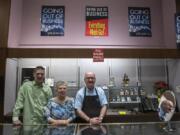 Chad Lanning, from left, Trudy Lanning and Joe Lanning pose behind the counter of My Jeweler in downtown Vancouver during their closing sale on Tuesday.